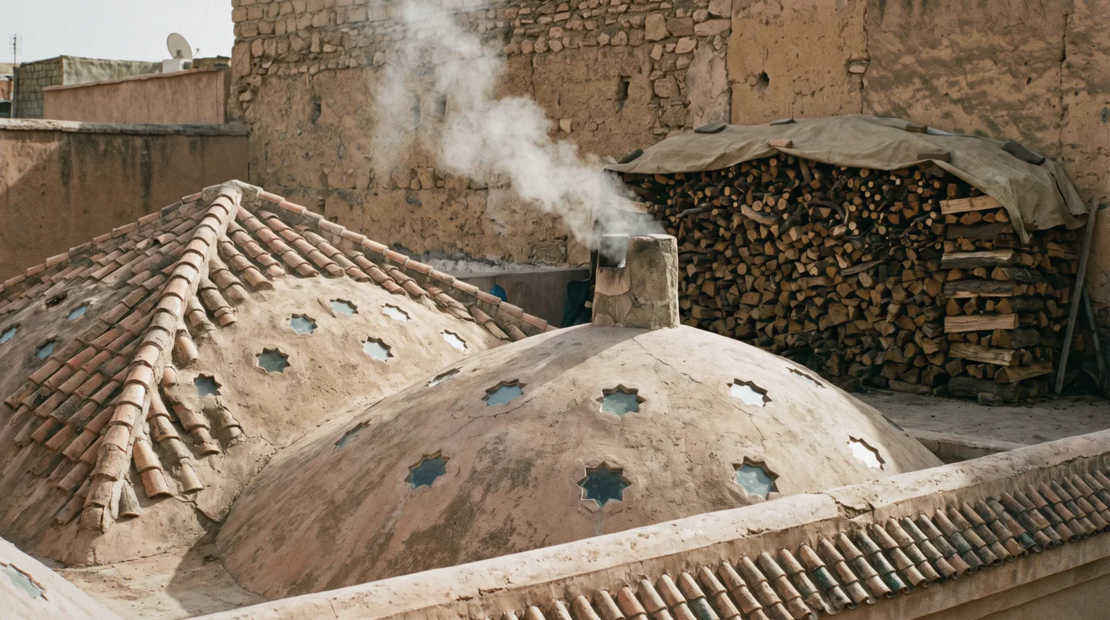 Steam, a marble slab and copper bowls in a tadelakt-walled washing room of a traditional Marrakech hammam